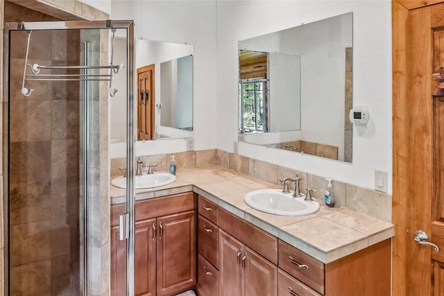 full bathroom featuring a stall shower and double vanity