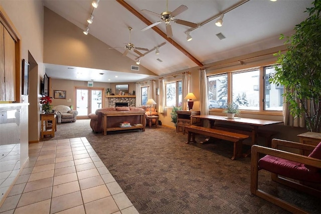 carpeted living room with tile patterned floors, a ceiling fan, a fireplace, and rail lighting