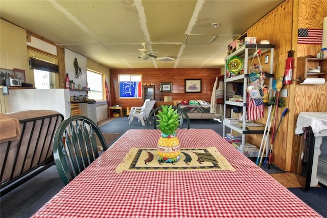 1091 Kokanee Rd, Fairplay, CO 80440 - dining area featuring wood walls, carpet floors, attic access, and ceiling fan