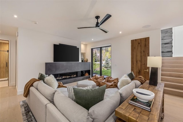 214 Windflower Ln, Frisco, CO 80443 - living area featuring light wood-style flooring, a ceiling fan, a glass covered fireplace, and recessed lighting
