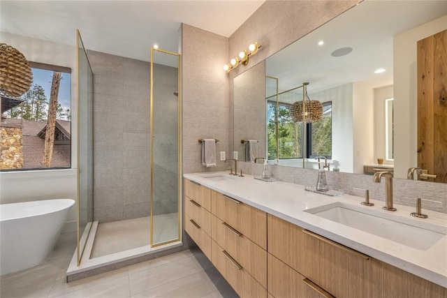 214 Windflower Ln, Frisco, CO 80443 - full bathroom with a freestanding bath, double vanity, a stall shower, and tile patterned flooring