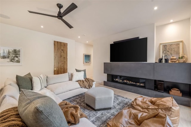 214 Windflower Ln, Frisco, CO 80443 - living room with ceiling fan, recessed lighting, wood finished floors, and a glass covered fireplace