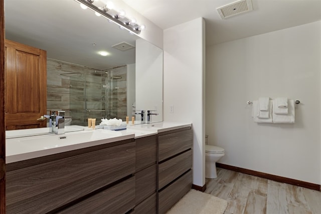 23110 US Highway 6 Unit 5074, Keystone, CO 80435 - bathroom featuring double vanity, a shower stall, toilet, wood finished floors, and baseboards