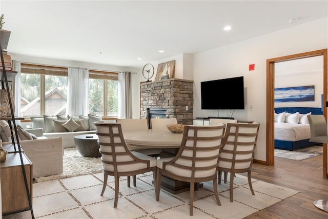 23110 US Highway 6 Unit 5074, Keystone, CO 80435 - dining room with a stone fireplace, light wood-style floors, recessed lighting, and baseboards