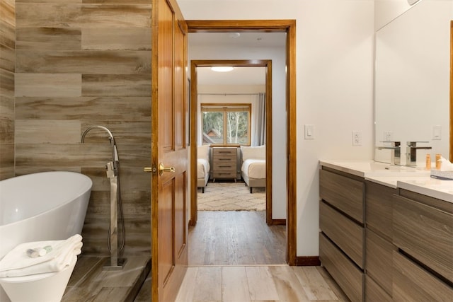 23110 US Highway 6 Unit 5074, Keystone, CO 80435 - bathroom with wood finished floors, vanity, a freestanding tub, and connected bathroom