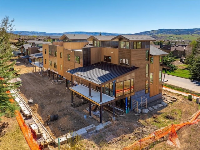 2948 Village Dr Unit 4, Steamboat Springs, CO 80487 - back of house with a mountain view, a residential view, metal roof, and a standing seam roof