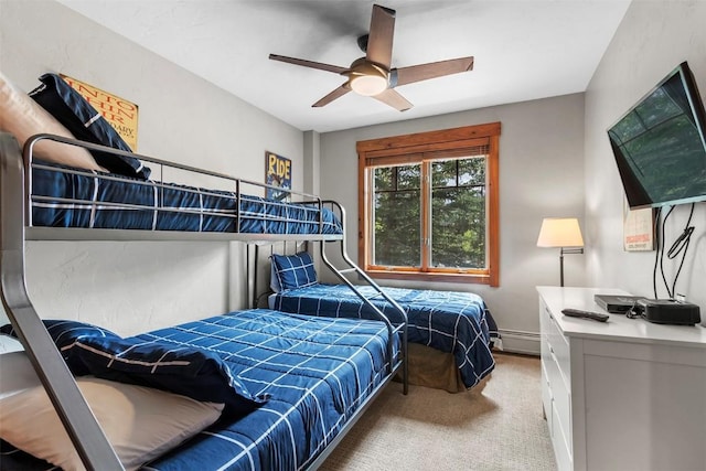 carpeted bedroom with baseboard heating and a ceiling fan