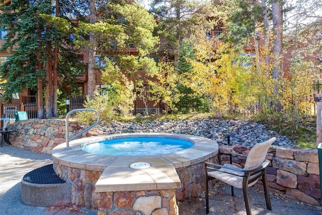 view of swimming pool featuring an in ground hot tub
