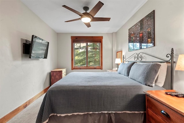 bedroom featuring baseboards, wood finished floors, and ceiling fan