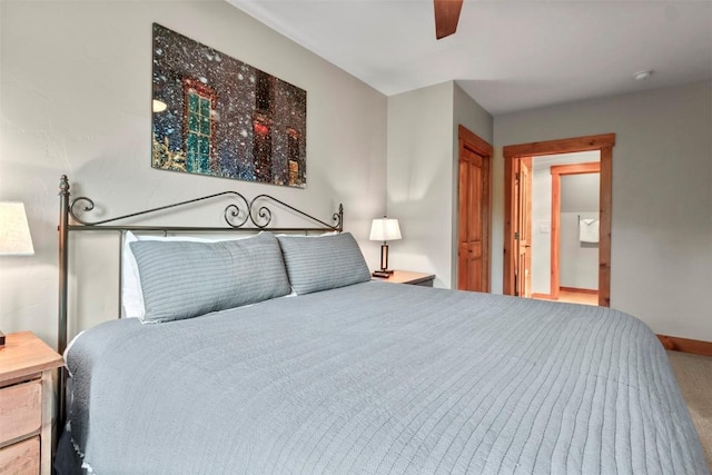 carpeted bedroom featuring baseboards and a ceiling fan