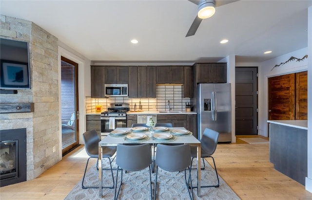 1090 Blue River Pkwy Unit 203, Silverthorne, CO 80498 - kitchen with appliances with stainless steel finishes, a sink, dark brown cabinetry, light wood-style flooring, and recessed lighting
