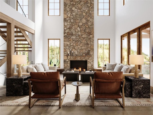 166 Woods Dr Unit 2, Breckenridge, CO 80424 - living area with a stone fireplace, a high ceiling, wood finished floors, and a healthy amount of sunlight