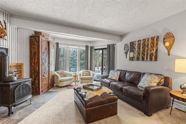 1179 Ski Hill Rd Unit 147, Breckenridge, CO 80424 - living room featuring a wood stove, a textured ceiling, and a baseboard radiator
