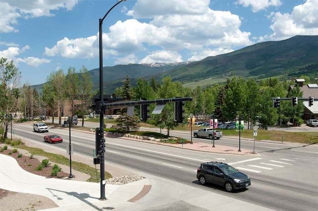 37 W 4th St Unit 201E, Silverthorne, CO 80498 - view of asphalt street with a mountain view, sidewalks, traffic lights, street lights, and traffic signs