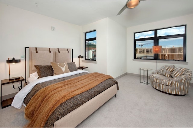 37 W 4th St Unit 201E, Silverthorne, CO 80498 - carpeted bedroom featuring multiple windows and a ceiling fan