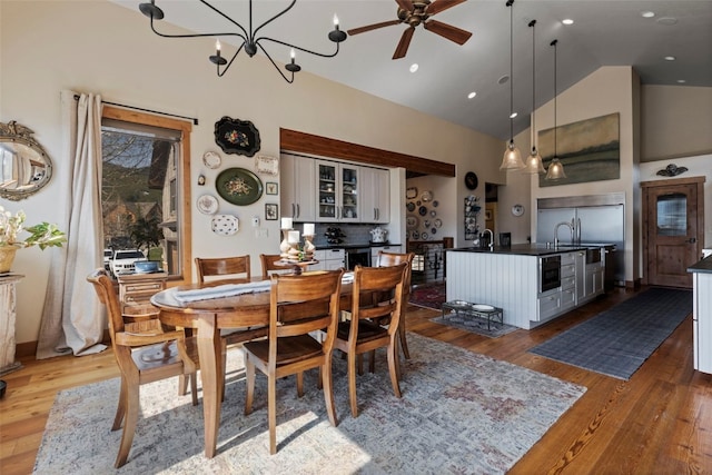 34 Snow Peak Ct, Dillon, CO 80435 - dining area featuring high vaulted ceiling, wood finished floors, ceiling fan, and a chandelier