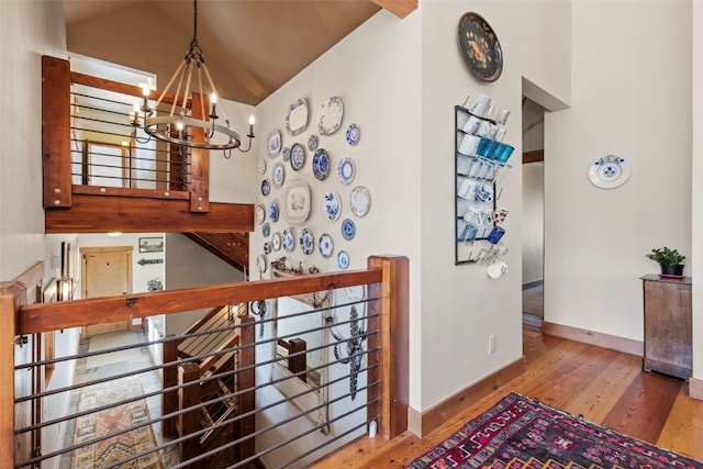34 Snow Peak Ct, Dillon, CO 80435 - corridor featuring a chandelier, an upstairs landing, wood finished floors, baseboards, and high vaulted ceiling