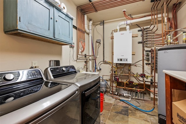 34 Snow Peak Ct, Dillon, CO 80435 - washroom featuring cabinet space, washing machine and clothes dryer, tankless water heater, and stone finish floors