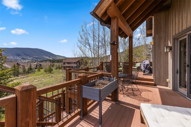 34 Snow Peak Ct, Dillon, CO 80435 - wooden terrace featuring a mountain view and outdoor dining space