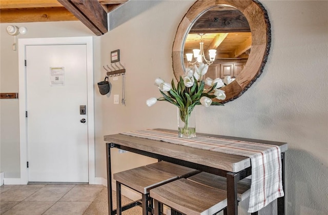 8500 Ryan Gulch Rd Unit G3, Silverthorne, CO 80498 - dining area with beam ceiling, a chandelier, baseboards, and light tile patterned floors