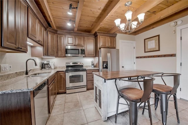 8500 Ryan Gulch Rd Unit G3, Silverthorne, CO 80498 - kitchen with appliances with stainless steel finishes, a sink, wood ceiling with exposed beams, light tile patterned floors, and a chandelier