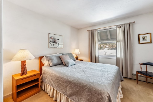 bedroom with light colored carpet and a baseboard radiator