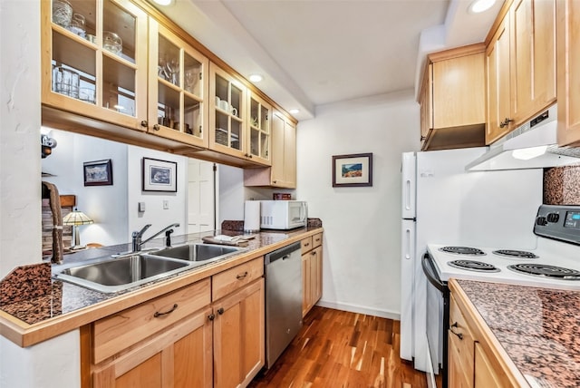 kitchen featuring kitchen peninsula, white appliances, sink, light brown cabinets, and dark hardwood / wood-style floors