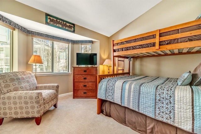 bedroom with carpet flooring and lofted ceiling