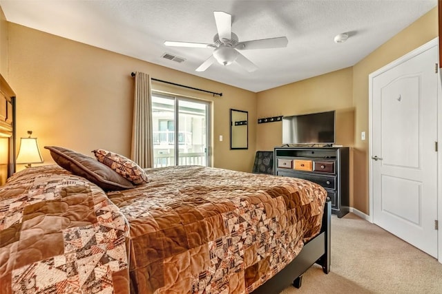 bedroom with a ceiling fan, a textured ceiling, access to exterior, light colored carpet, and visible vents