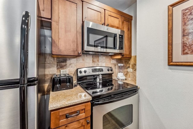 100 S Park Ave Unit E111, 112, Breckenridge, CO 80424 - kitchen with stainless steel appliances, backsplash, brown cabinetry, and light stone countertops