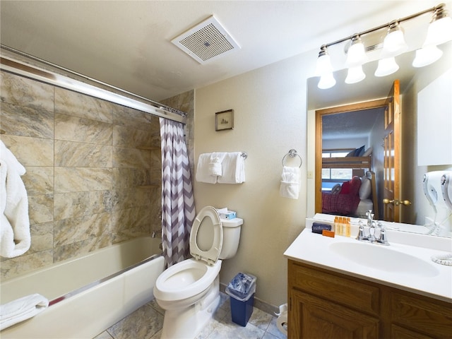 full bathroom featuring shower / bath combo with shower curtain, vanity, and toilet