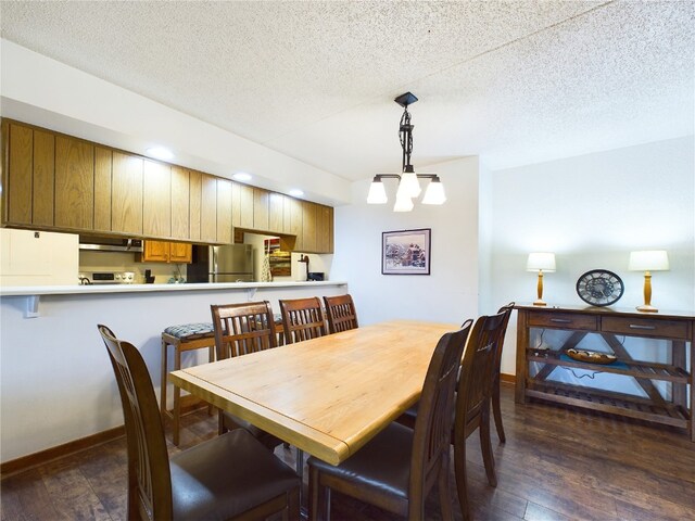 dining room featuring dark hardwood / wood-style floors and a textured ceiling