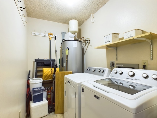 washroom with light tile patterned floors, a textured ceiling, electric water heater, and washing machine and clothes dryer