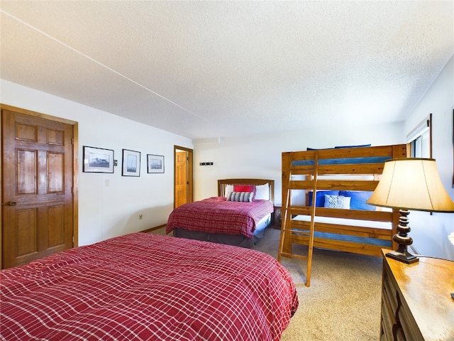 carpeted bedroom featuring a textured ceiling