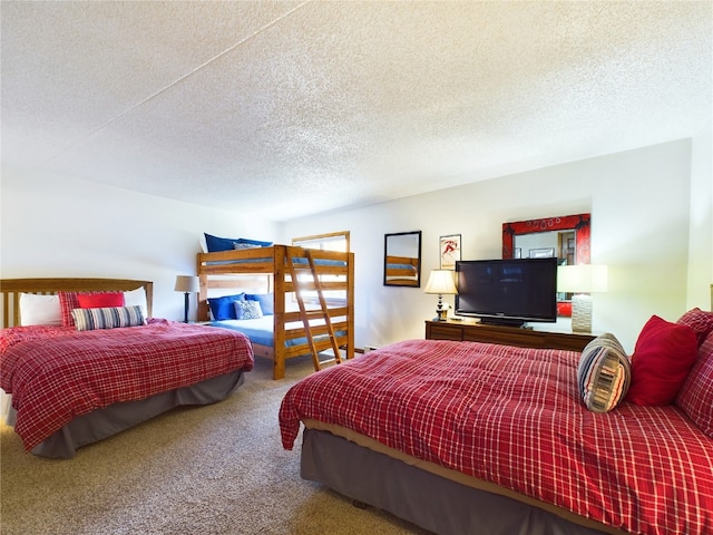 bedroom with carpet and a textured ceiling