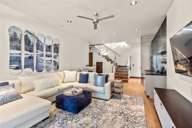 living room featuring ceiling fan and light wood-type flooring