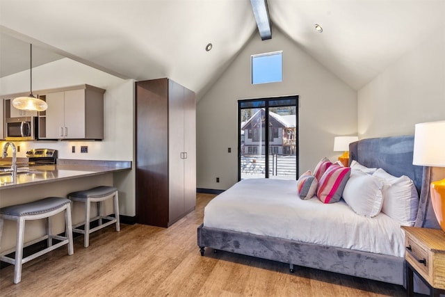 bedroom with vaulted ceiling with beams and light wood-type flooring