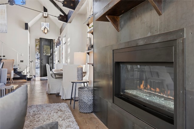 living room featuring hardwood / wood-style flooring and vaulted ceiling