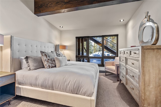 carpeted bedroom with beamed ceiling