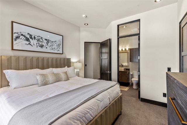 bedroom featuring carpet flooring, ensuite bath, and sink