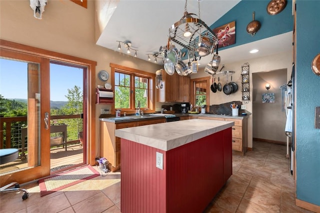 57610 Longfellow Way, Clark, CO 80428 - kitchen with a kitchen island, light countertops, light tile patterned flooring, and lofted ceiling