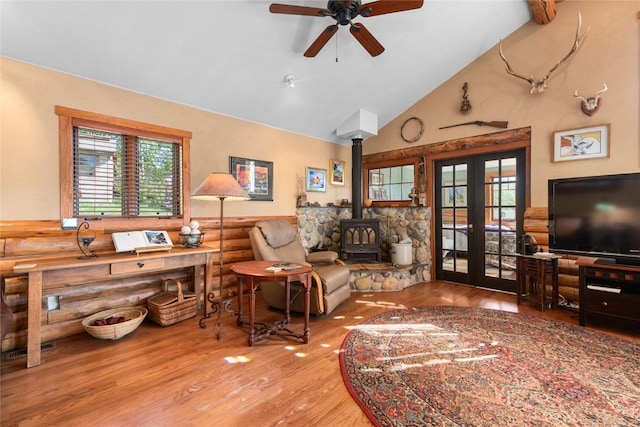 57610 Longfellow Way, Clark, CO 80428 - living area featuring a wood stove, french doors, wood finished floors, ceiling fan, and high vaulted ceiling