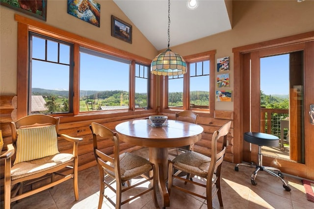 57610 Longfellow Way, Clark, CO 80428 - tiled dining area featuring log walls and lofted ceiling