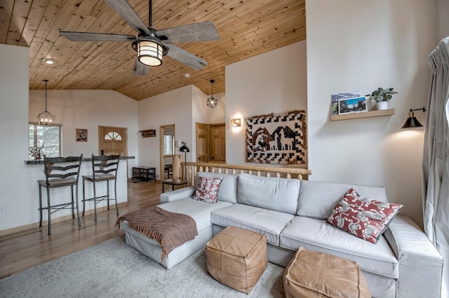 living area featuring high vaulted ceiling, wood finished floors, a ceiling fan, and wood ceiling