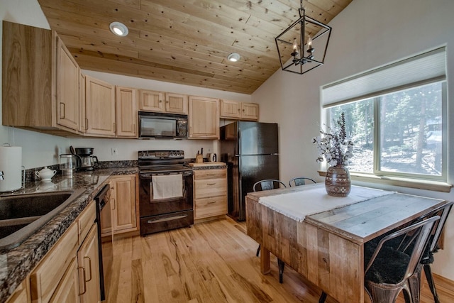 kitchen with dark countertops, light wood-style flooring, light brown cabinetry, and black appliances