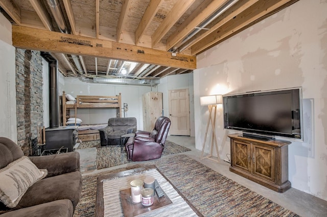 living area with concrete flooring and a wood stove