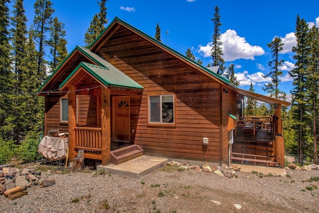 view of front of house featuring a wooden deck and metal roof