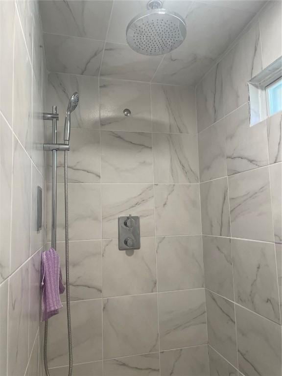full bath with a tile shower