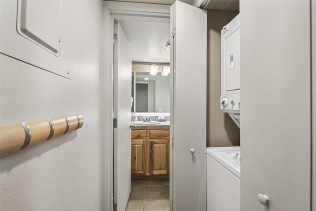 22097 Saints John Rd Unit 2537, Keystone, CO 80435 - laundry room featuring stacked washer / dryer and light tile patterned floors