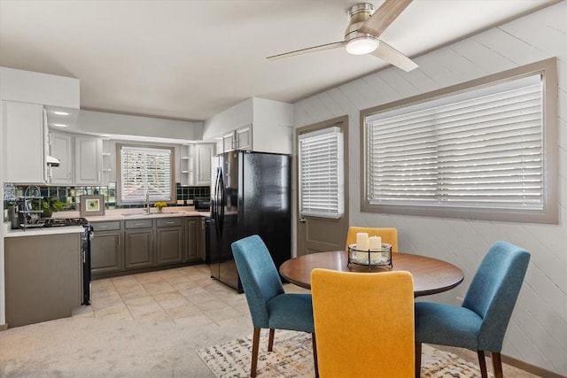 818 Broad St, Steamboat Springs, CO 80487 - dining room with wood walls, ceiling fan, and light carpet